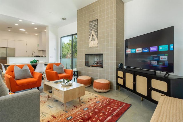 living room featuring a tiled fireplace