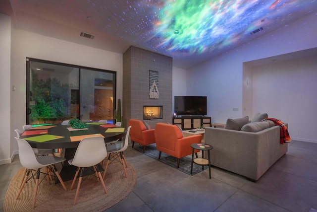 living room featuring a fireplace and concrete floors