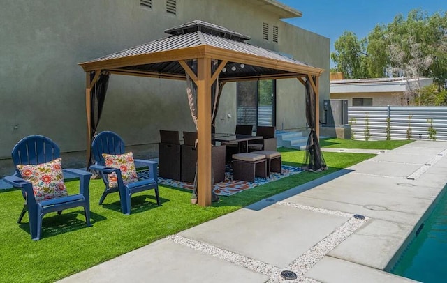 view of patio featuring a pool and a gazebo