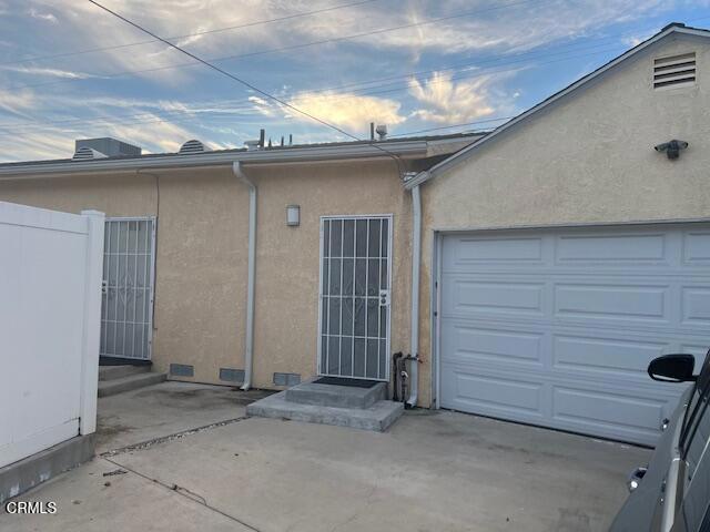 back of property featuring a garage