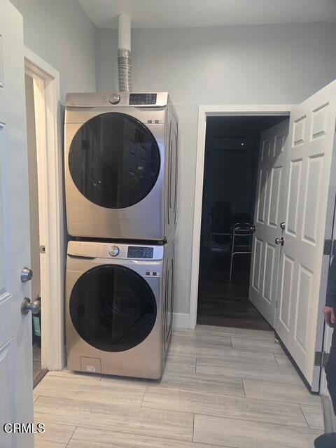 washroom with stacked washer and clothes dryer