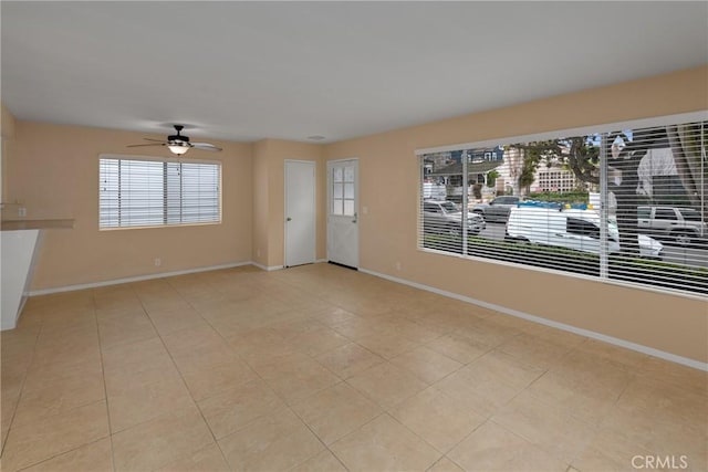 interior space with light tile patterned flooring and ceiling fan