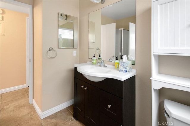 bathroom featuring an enclosed shower, vanity, tile patterned floors, and toilet