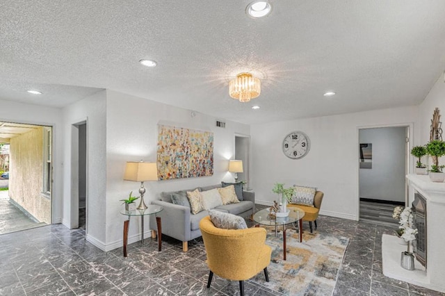 living room with a textured ceiling and a notable chandelier