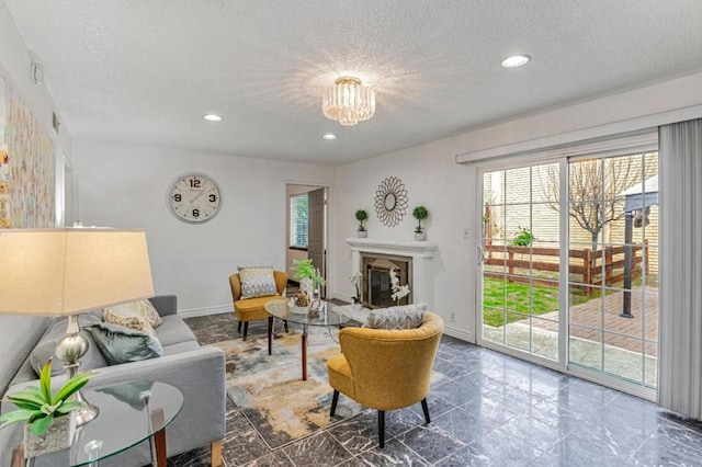 living room with an inviting chandelier and a textured ceiling