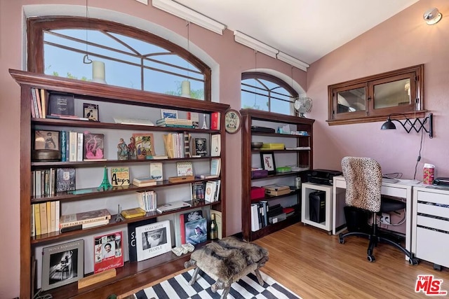 office space featuring lofted ceiling and hardwood / wood-style flooring