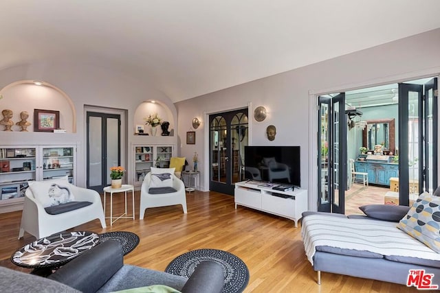 living room featuring hardwood / wood-style floors and vaulted ceiling