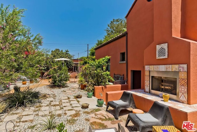 view of patio with a tile fireplace