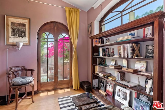 sitting room featuring french doors and light hardwood / wood-style flooring