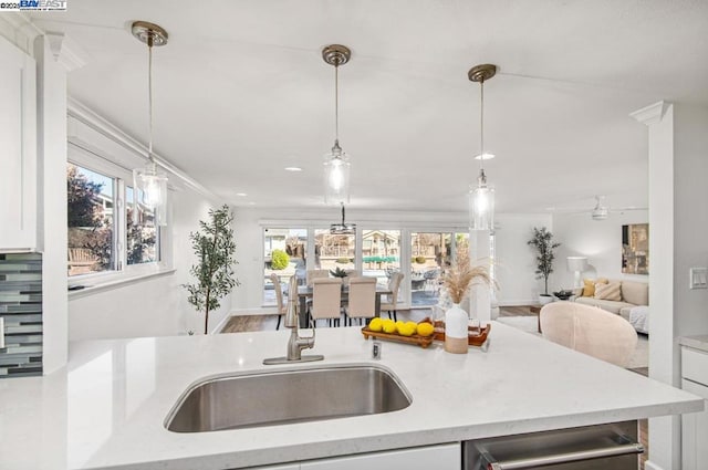 kitchen with pendant lighting, sink, and hardwood / wood-style floors