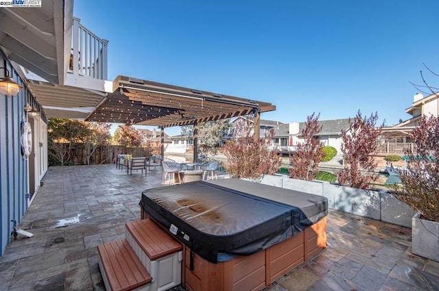 view of patio with a pergola and a hot tub