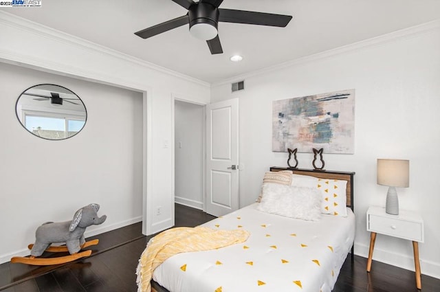 bedroom featuring crown molding, dark wood-type flooring, and ceiling fan