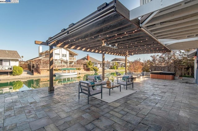 view of patio / terrace featuring an outdoor hangout area and a hot tub