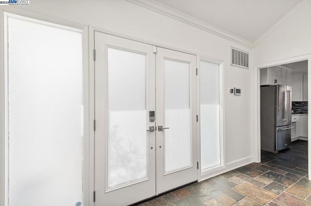 doorway featuring crown molding and french doors