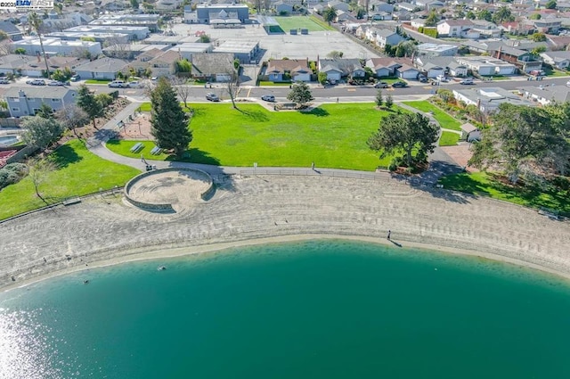 birds eye view of property with a beach view and a water view