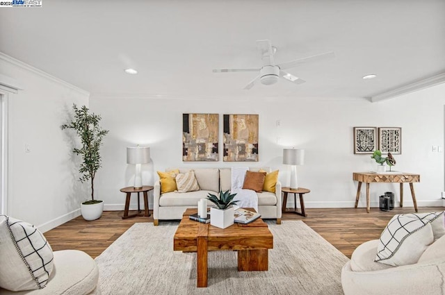 living room with hardwood / wood-style flooring, ornamental molding, and ceiling fan