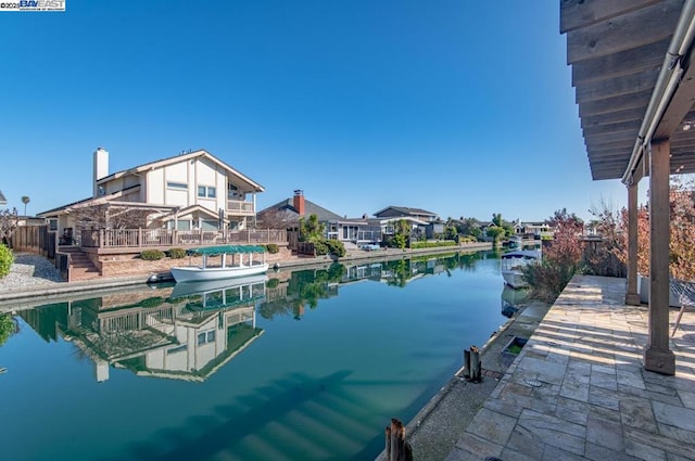 dock area with a patio area and a water view