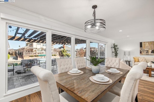 dining area featuring hardwood / wood-style flooring and ornamental molding