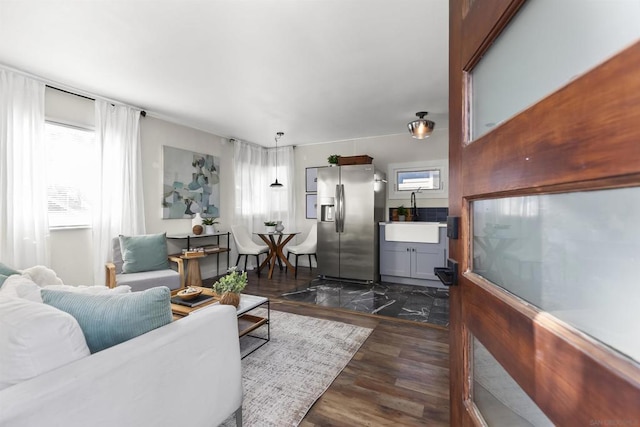 living room with dark wood-type flooring and sink