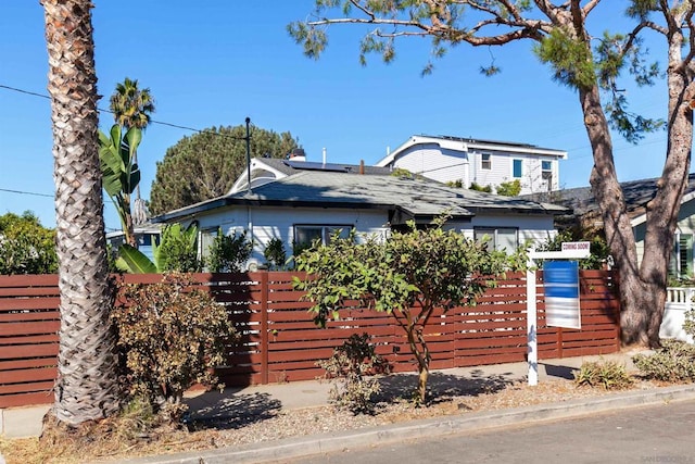 view of front of property featuring solar panels