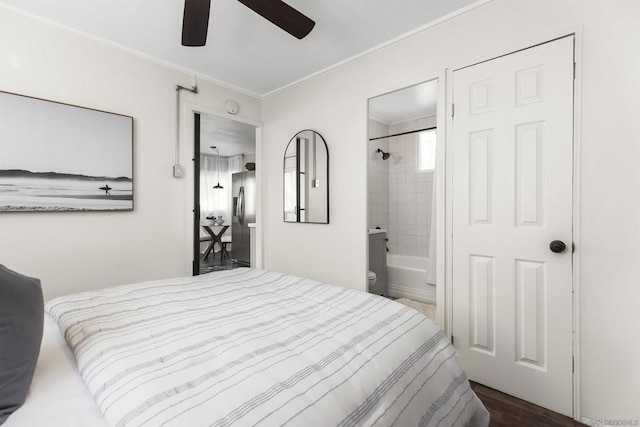 bedroom featuring dark wood-type flooring, ensuite bath, stainless steel fridge with ice dispenser, ornamental molding, and ceiling fan