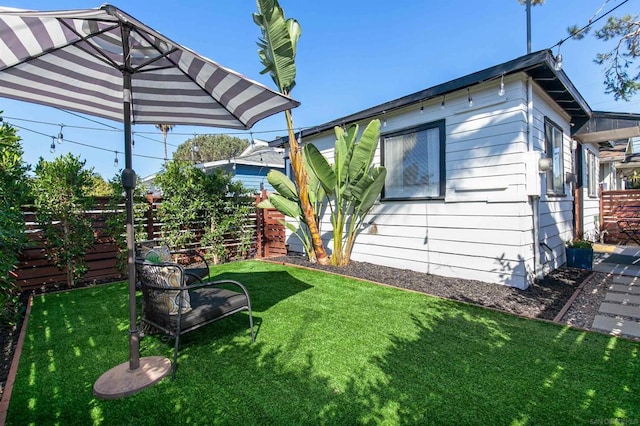 view of side of home featuring a lawn