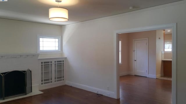 unfurnished living room featuring dark hardwood / wood-style floors and a fireplace