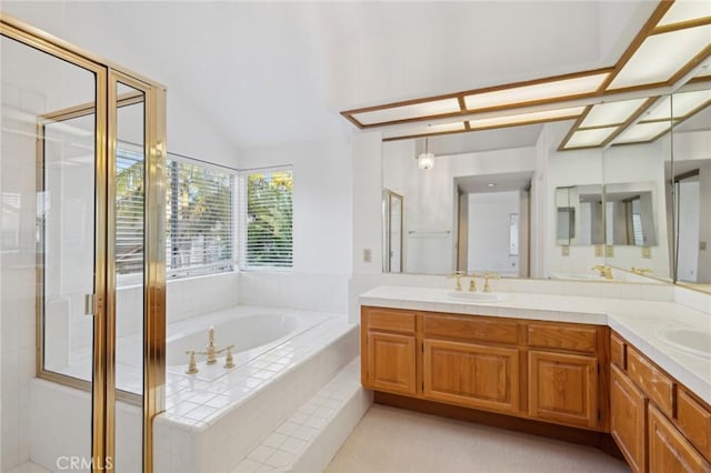 bathroom with lofted ceiling, vanity, and independent shower and bath