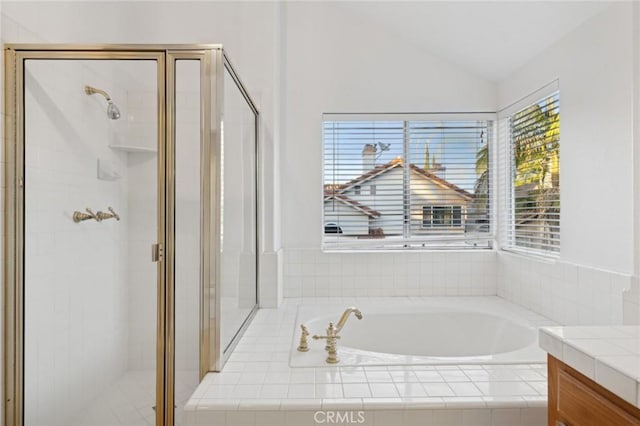 bathroom featuring vanity, vaulted ceiling, and plus walk in shower