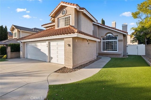 view of front of property featuring a garage and a front lawn