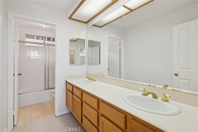 full bathroom with vanity, shower / bath combination with glass door, and toilet