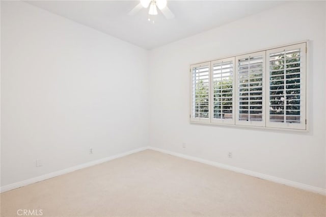 spare room featuring ceiling fan and carpet floors