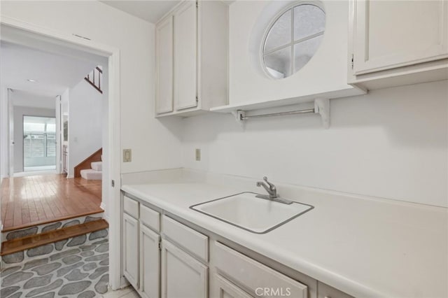 kitchen featuring sink and white cabinets