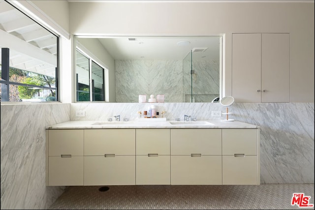 bathroom with vanity and tile walls