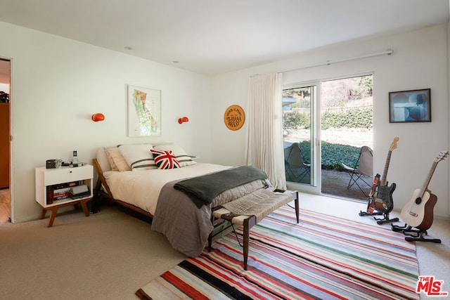 bedroom featuring access to exterior and light colored carpet