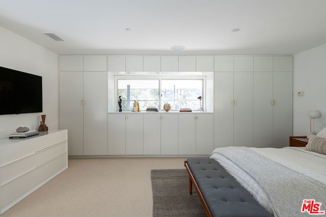 bedroom featuring light carpet