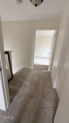 hall featuring carpet flooring