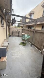 view of patio featuring fence