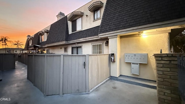 patio terrace at dusk featuring fence