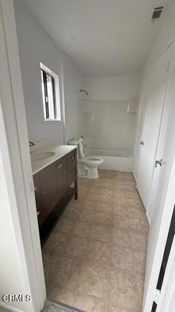 bathroom featuring toilet, visible vents, shower / bathing tub combination, and vanity