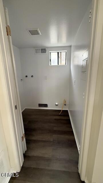 washroom with visible vents and wood finished floors