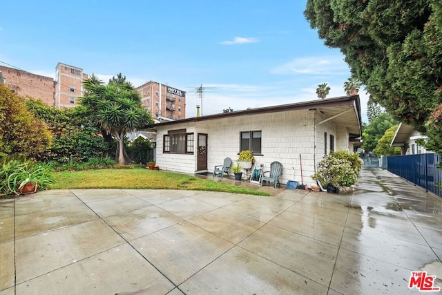 rear view of property featuring a yard