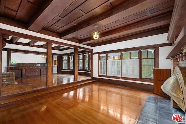 interior space with beamed ceiling and a fireplace