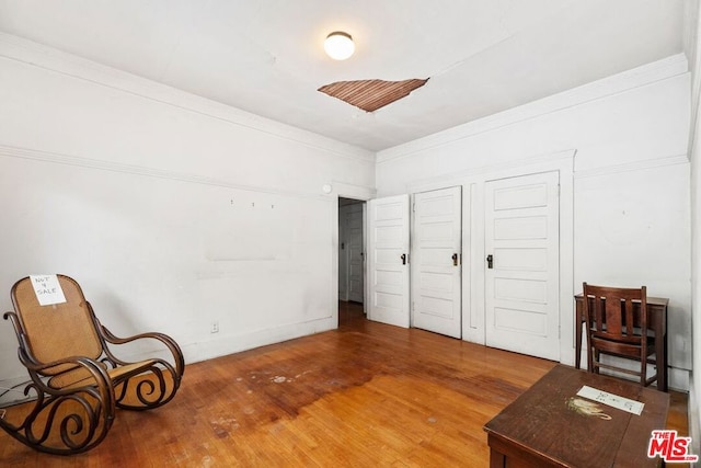 bedroom featuring hardwood / wood-style flooring and ornamental molding