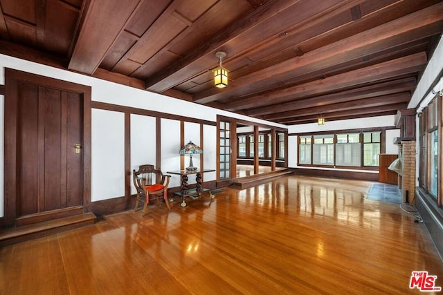 interior space with beamed ceiling, wood-type flooring, and wood ceiling