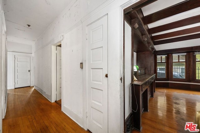 corridor featuring beamed ceiling and dark wood-type flooring