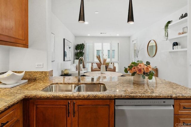 kitchen with sink, hanging light fixtures, light stone countertops, stainless steel dishwasher, and kitchen peninsula