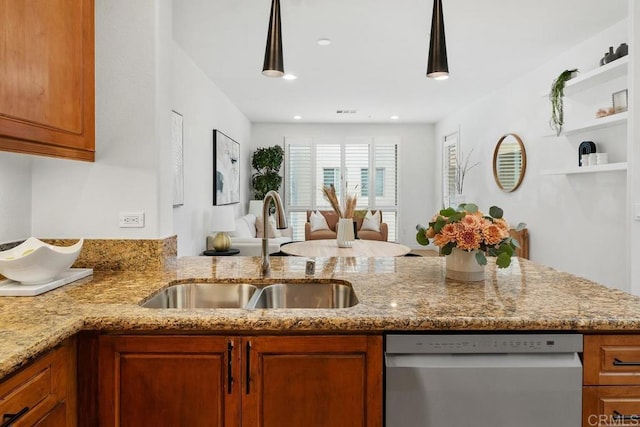 kitchen featuring brown cabinetry, a sink, and dishwasher