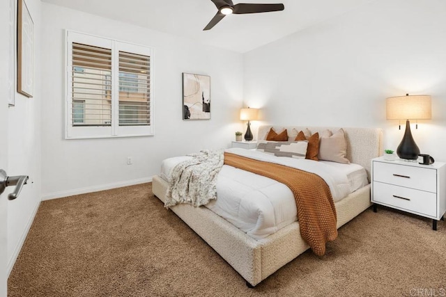 carpeted bedroom featuring baseboards and a ceiling fan