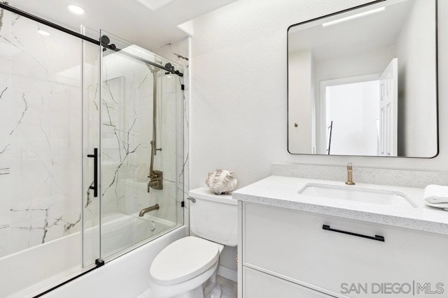 full bathroom featuring toilet, vanity, and bath / shower combo with glass door